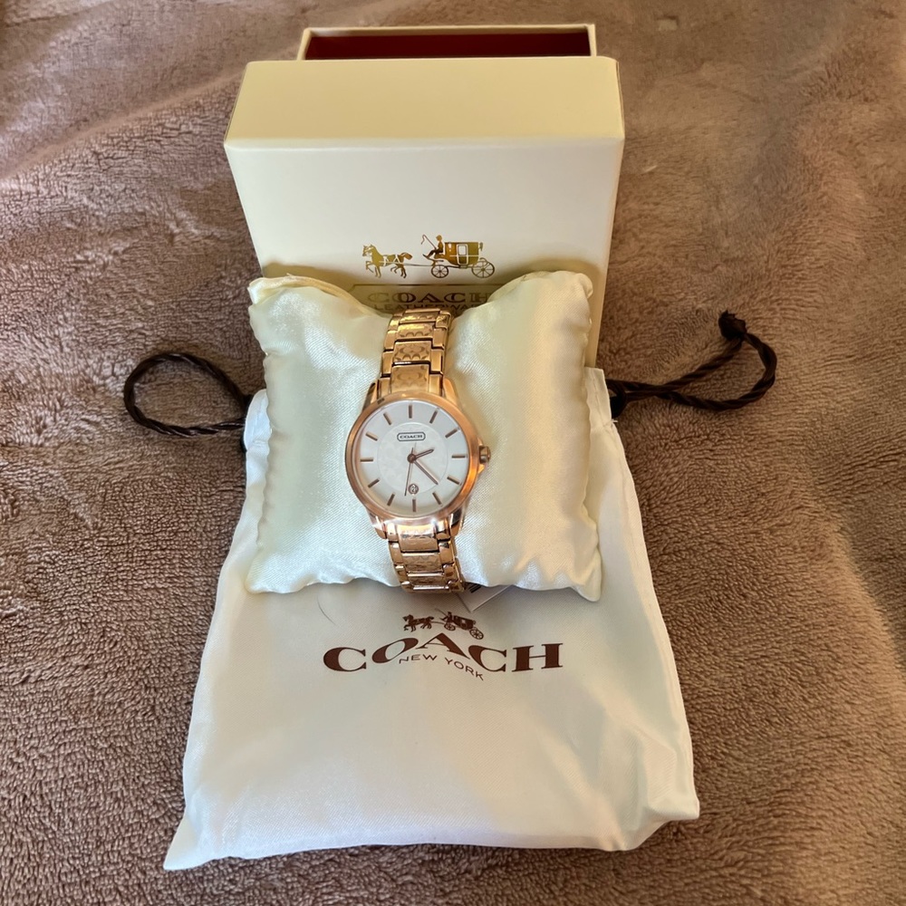 Coach rose gold etched face watch.
